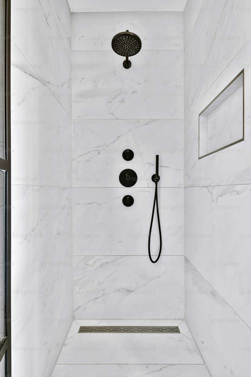 New black shower head on holder in white tiled bathroom in modern apartment  Stock Photo - Alamy