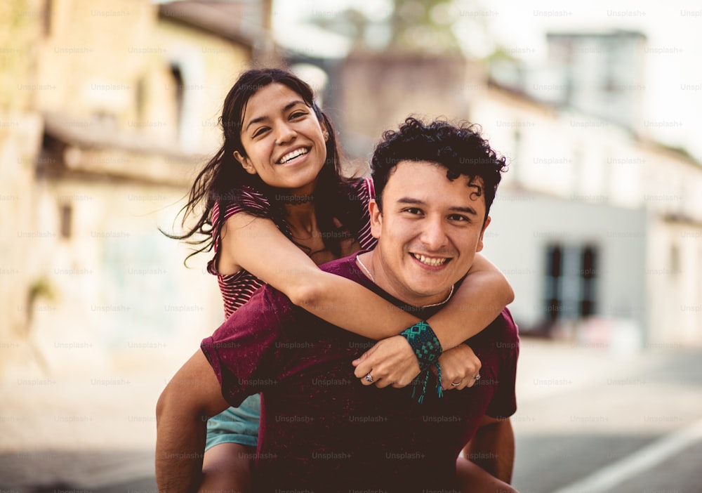 Young happy couple spending time on the street.