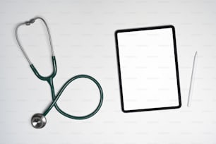 Above view stethoscope and digital tablet on white background.