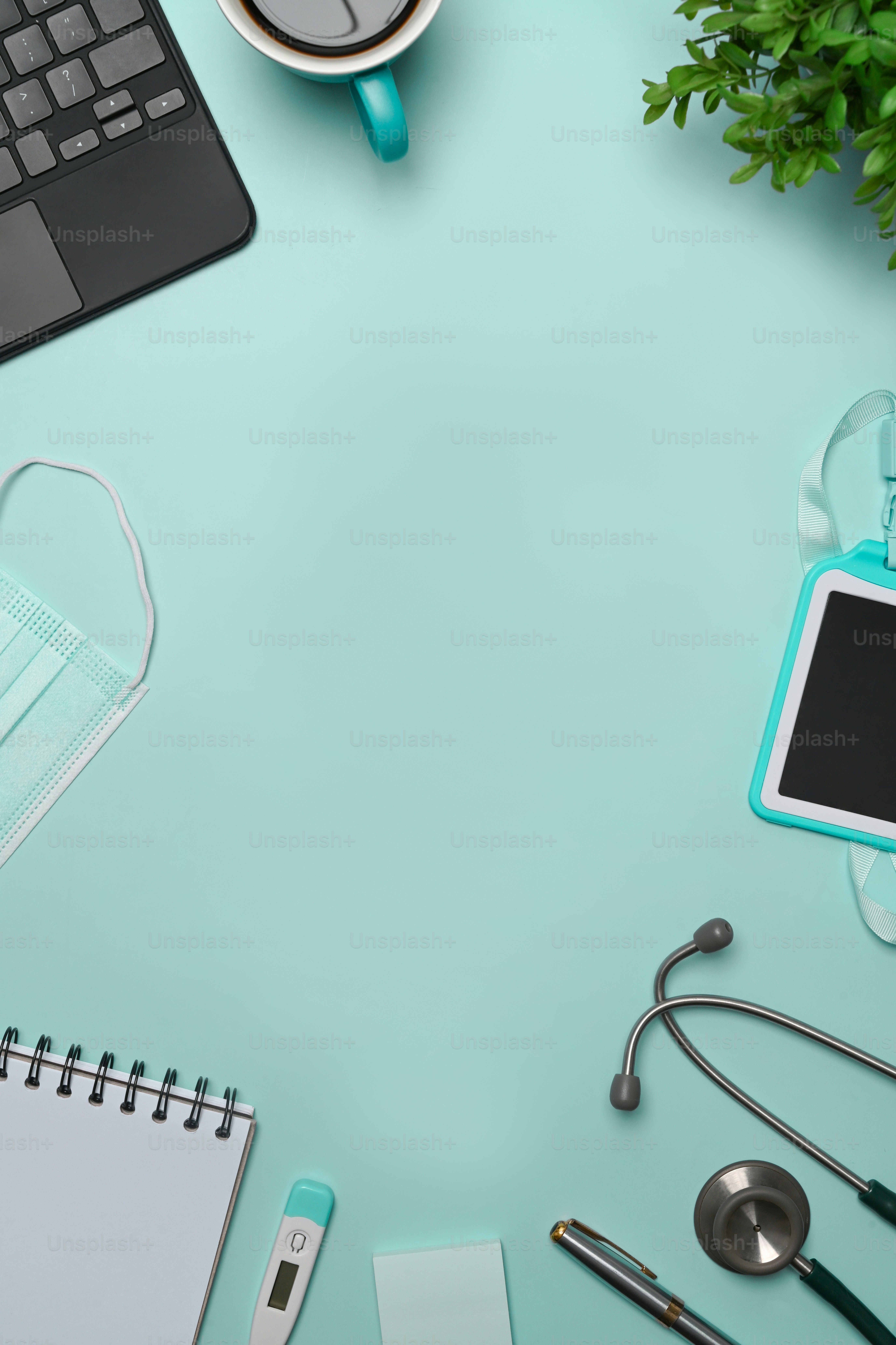 Top view doctor workspace with laptop computer, stethoscope, notebook and coffee cup.