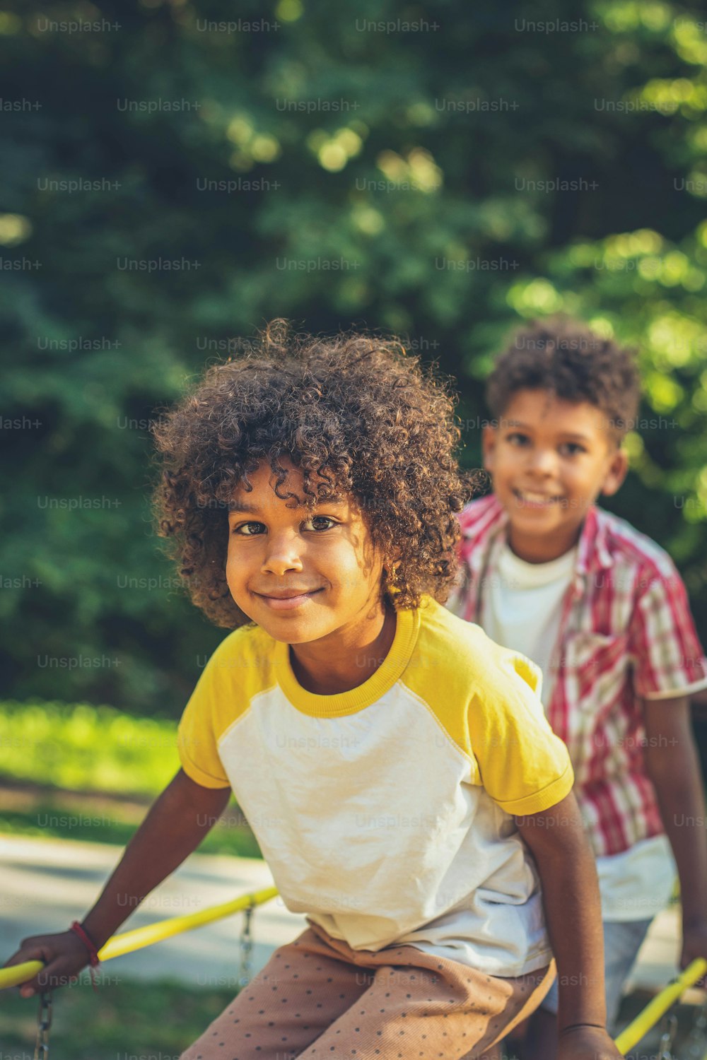 African American kids playing on bridge. Brother and sister. Focus is on little girl.