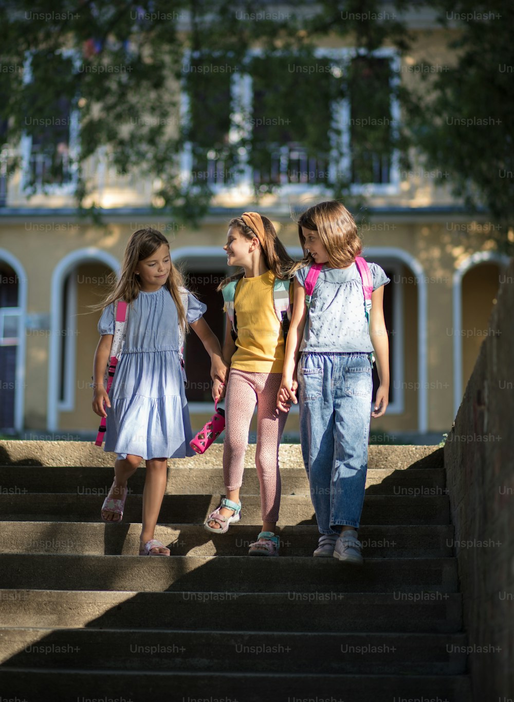 The three girls return from school together.