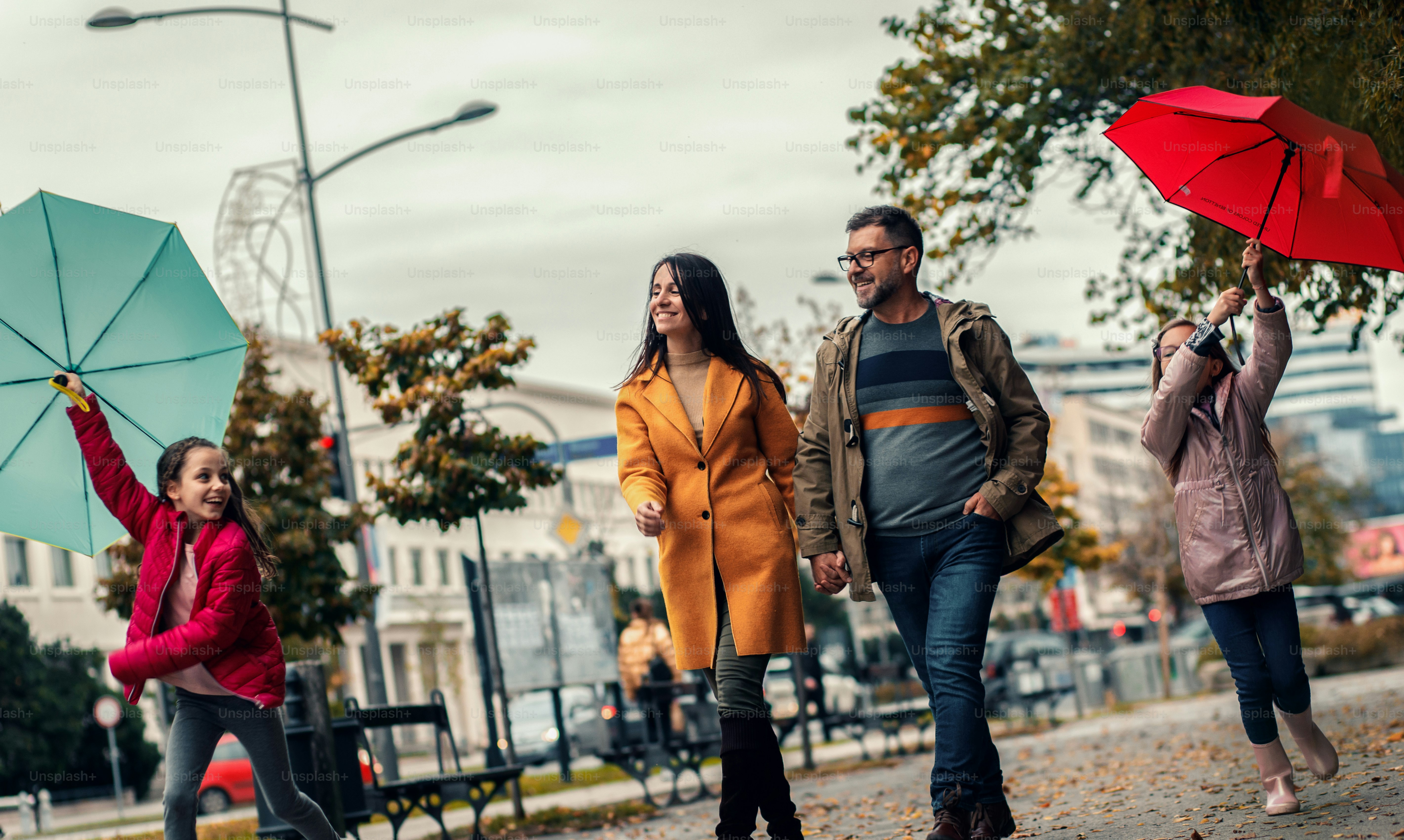 Family of four enjoying together walking through the city.