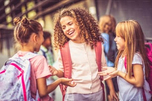 Group of elementary age schoolchildren outside. Focus is on foreground.