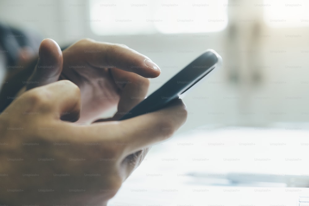 Young man using mobile phone. Using online connect technology for business, education and communication.