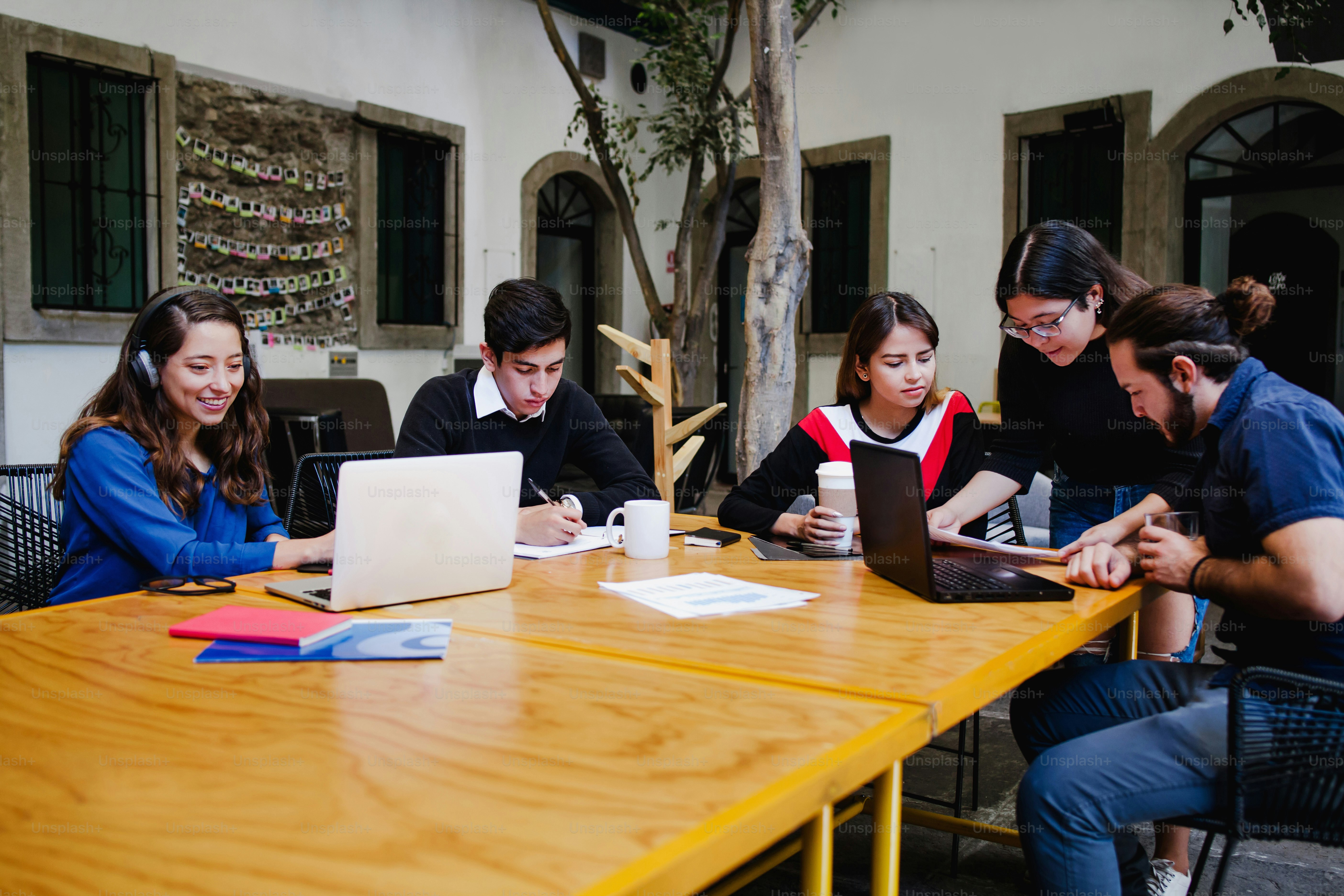 Group of young latin business people busy working on project outside the office in Mexico