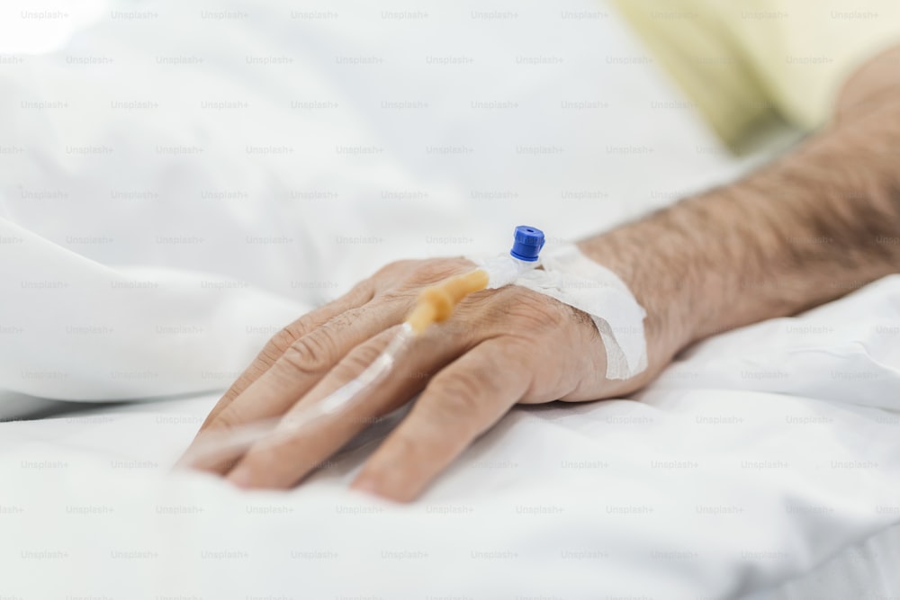 Cropped image of IV drip on patient hand.