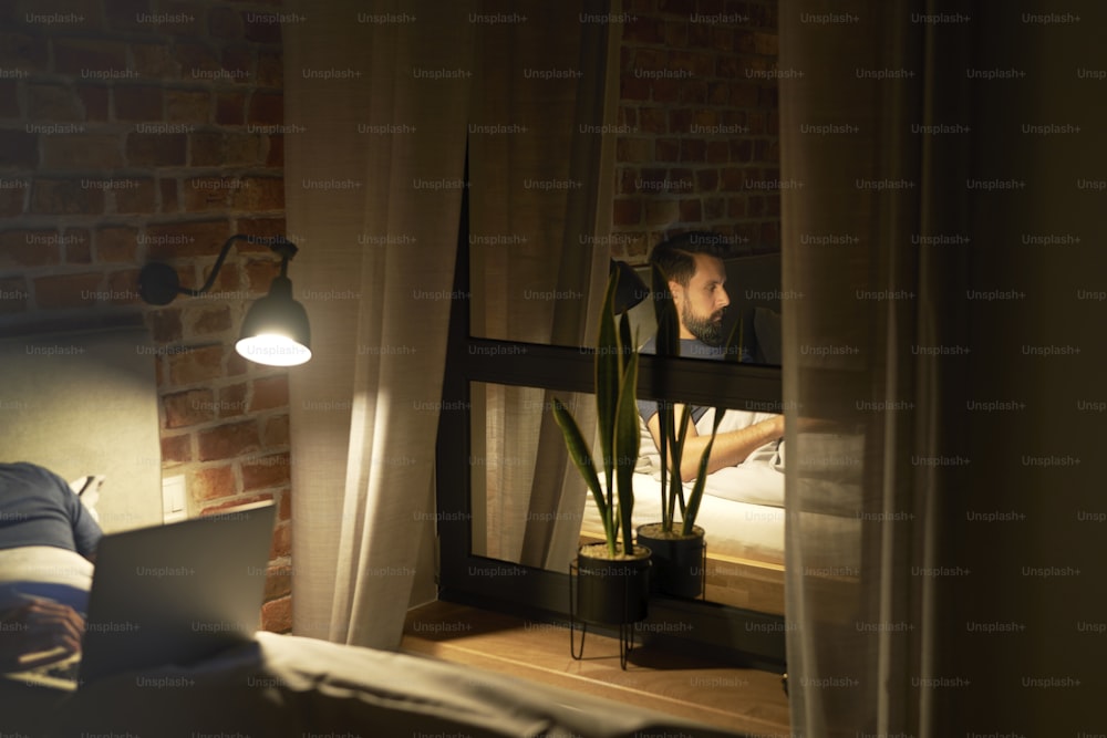 Man working until late reflected in the window
