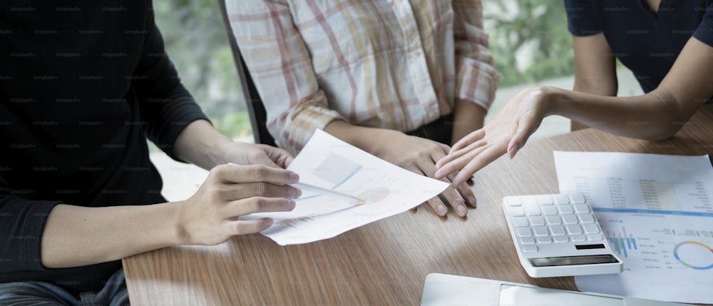 Businesspeople analyzing report together in office.