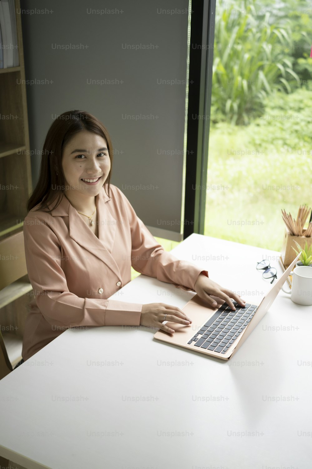 Confident businesswoman working with laptop computer at office.