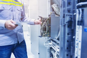 Technician using digital tablet in server room, repair card mainboard checking network link status