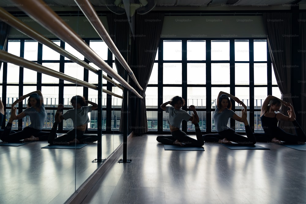 Group Of Asian People Practicing Yoga Indoor Studio Background