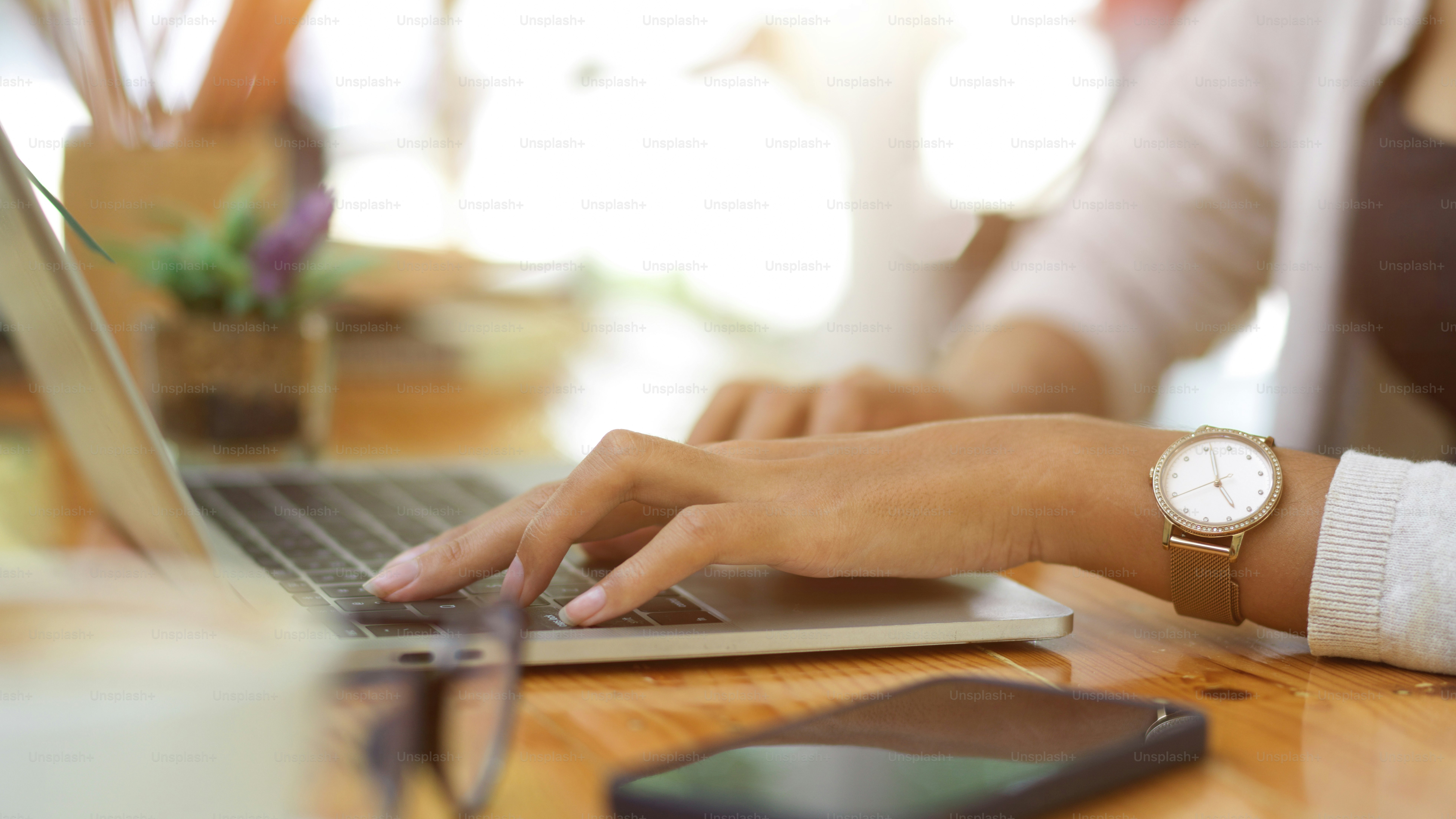 Cropped shot of female typing on laptop, work from home, informal ...