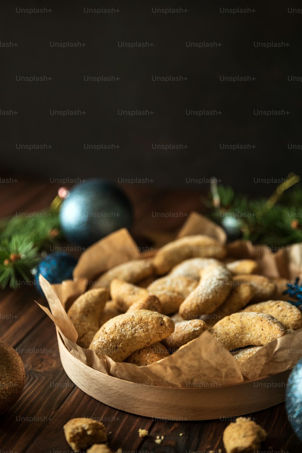 Homemade Christmas nuts cookies vanilla crescent with sugar powder in Christmas decorations. New Year and Christmas celebration concept. Copy space. Soft focus. Front view