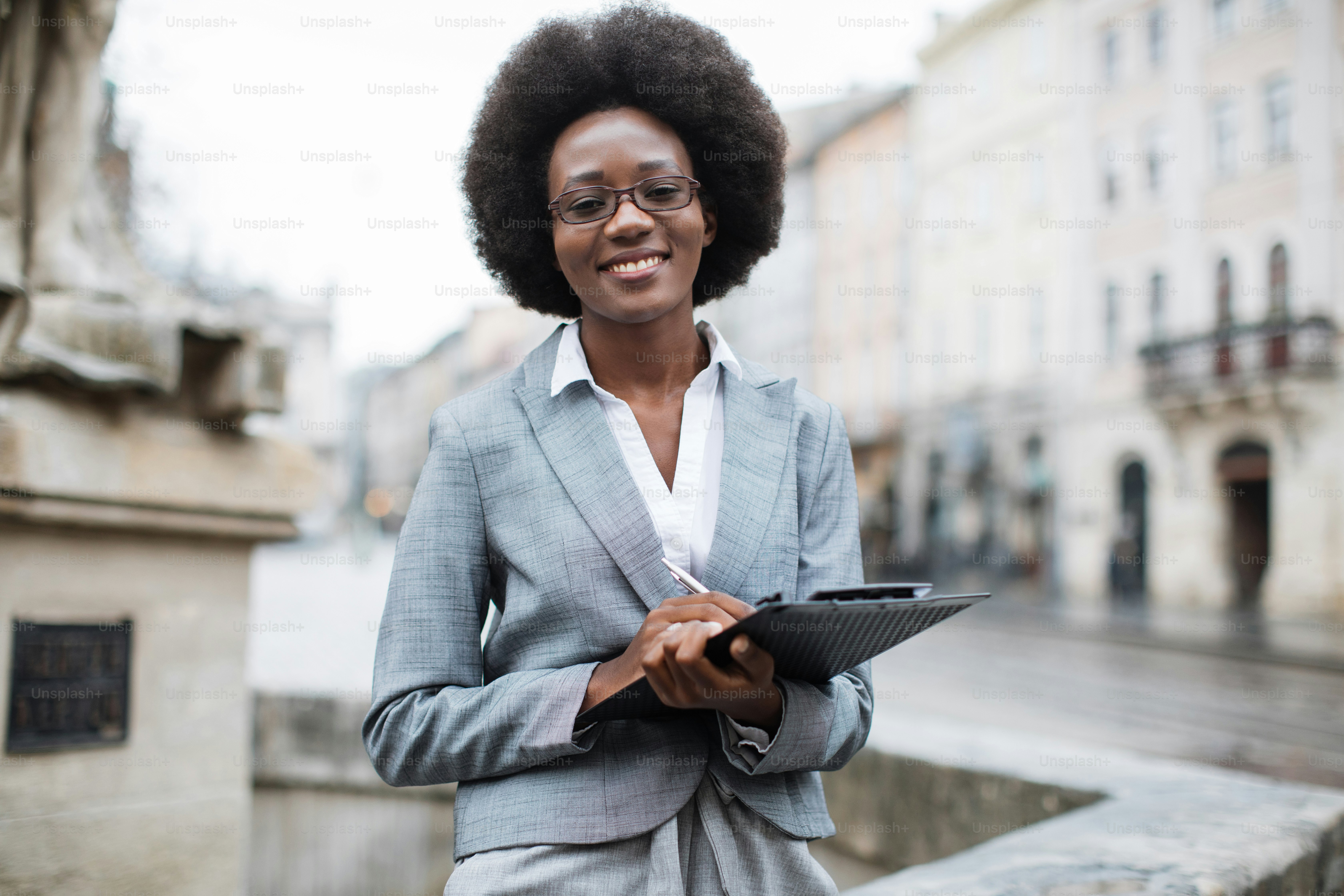 Front view of smiling african business woman in stylish formal clothes ...