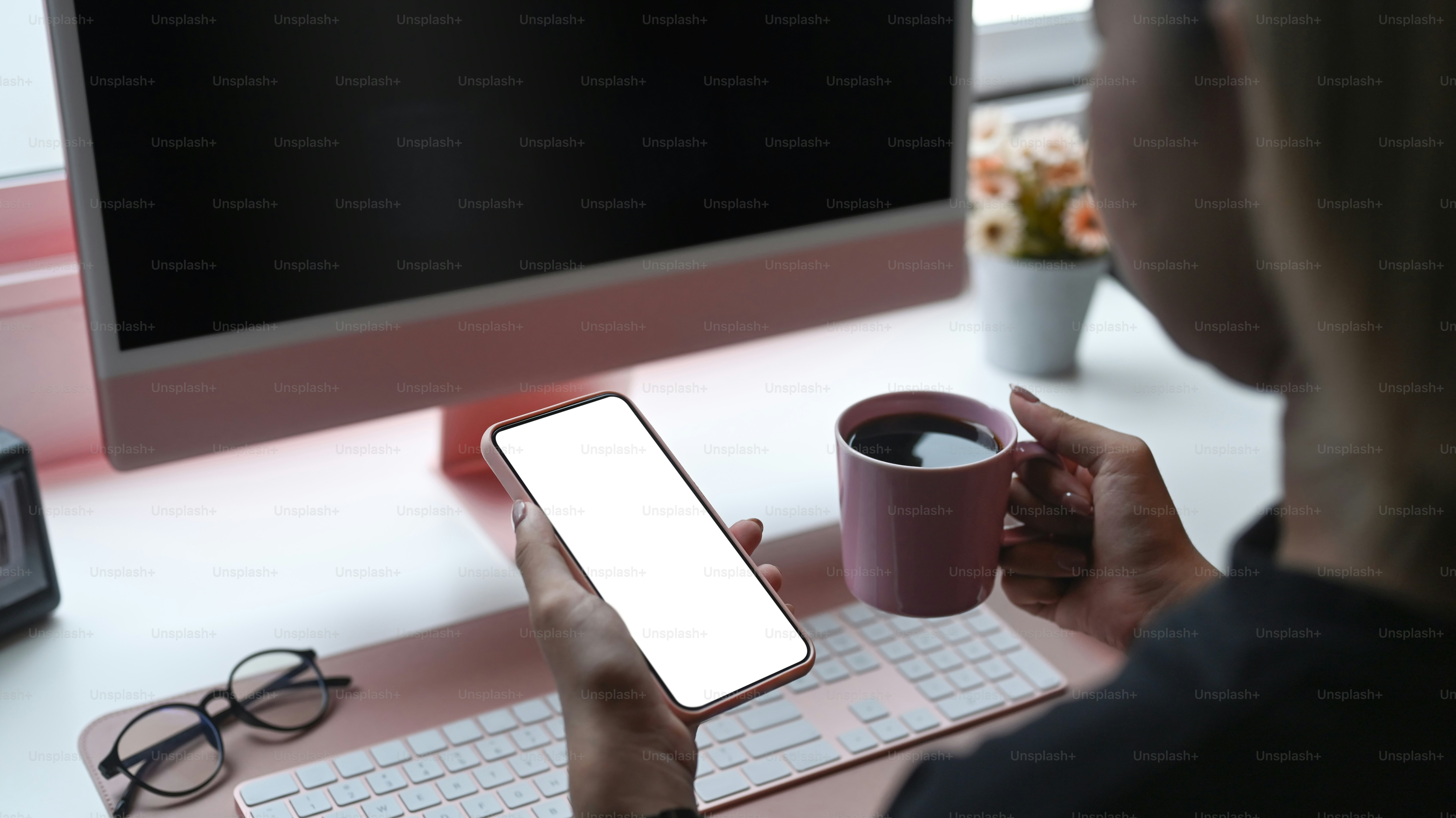 Cropped shot young female drinking coffee and using smart phone.