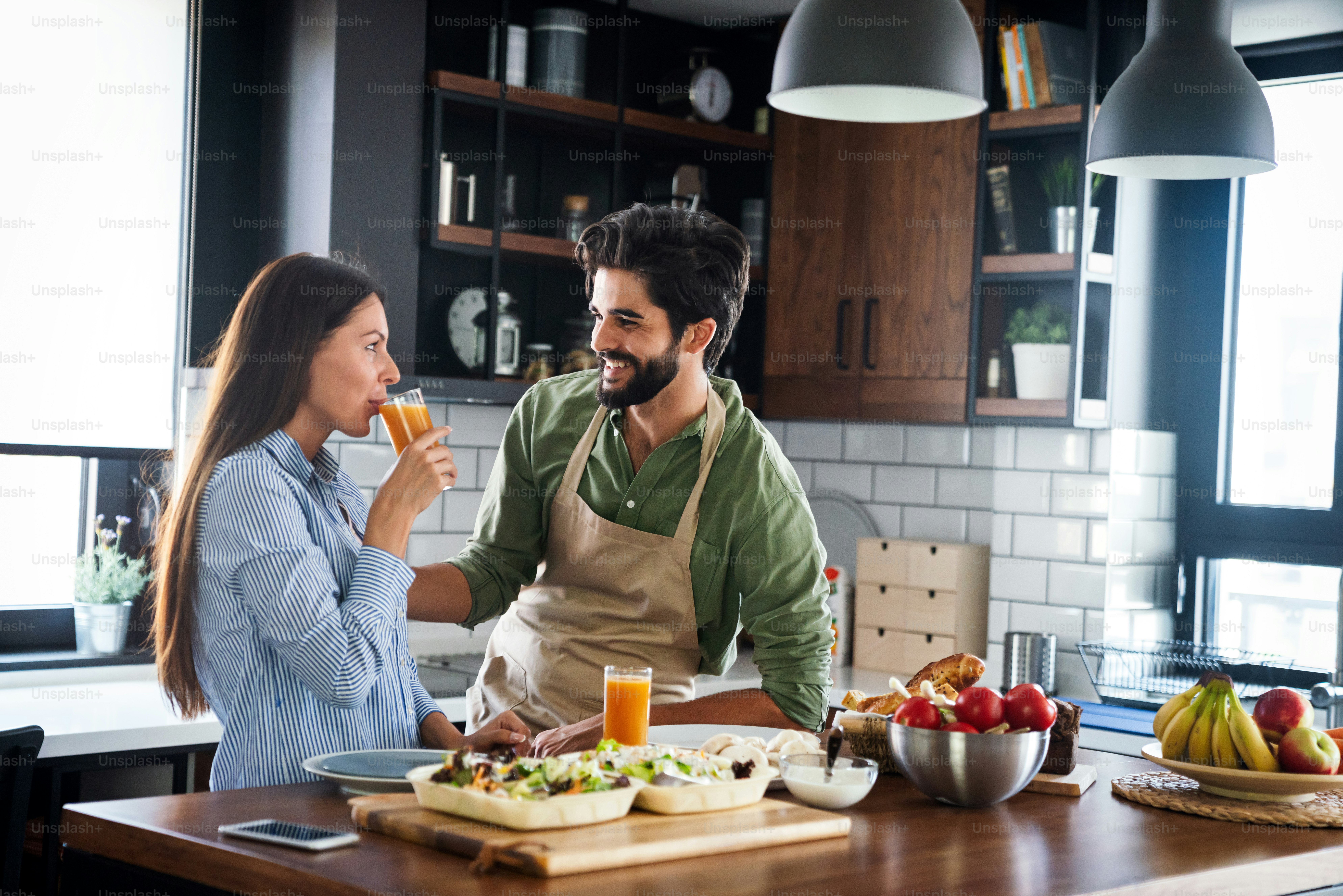 Happy young couple cooking together in the kitchen at home