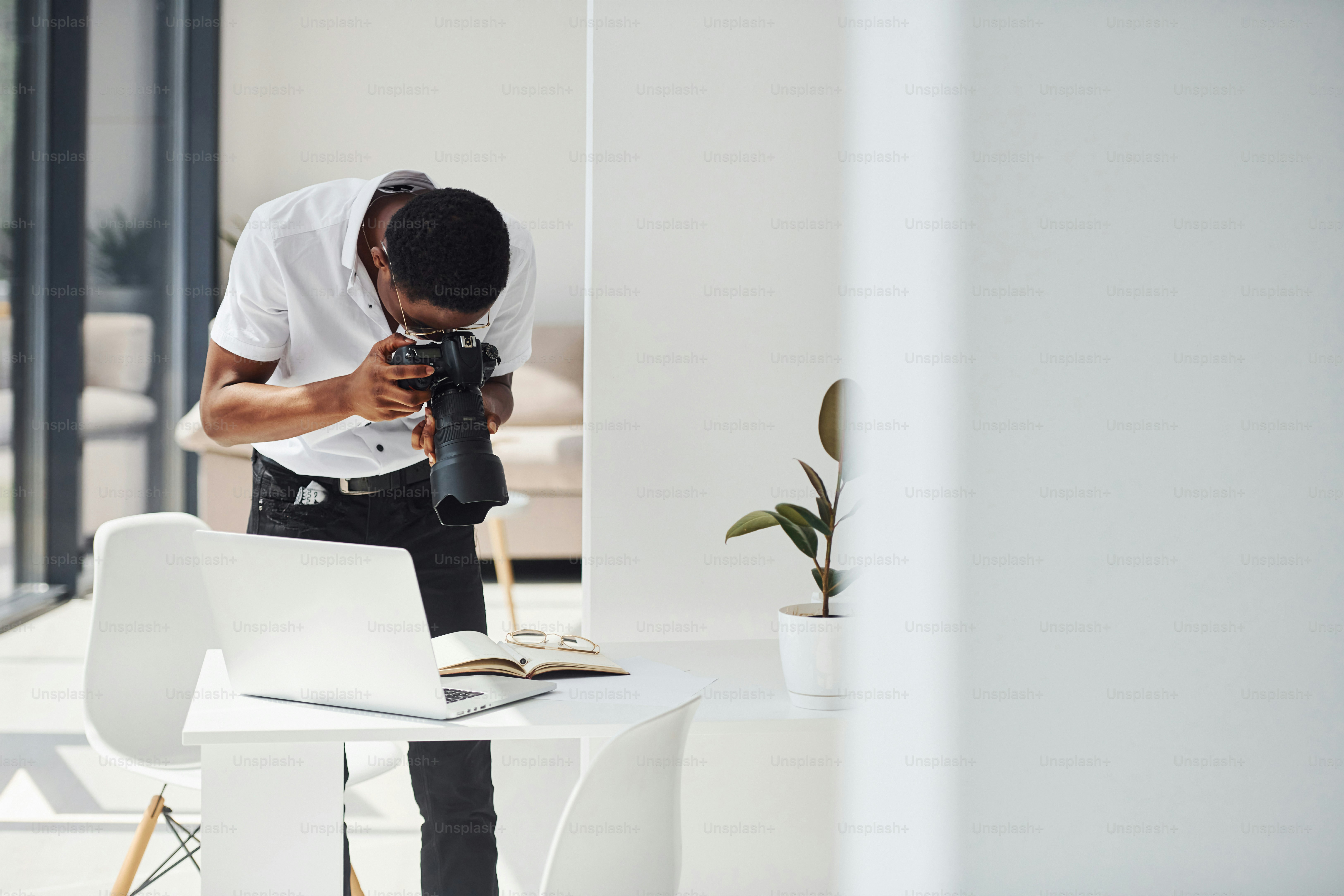 Testing camera. Young african american man in formal clothes is in the office.