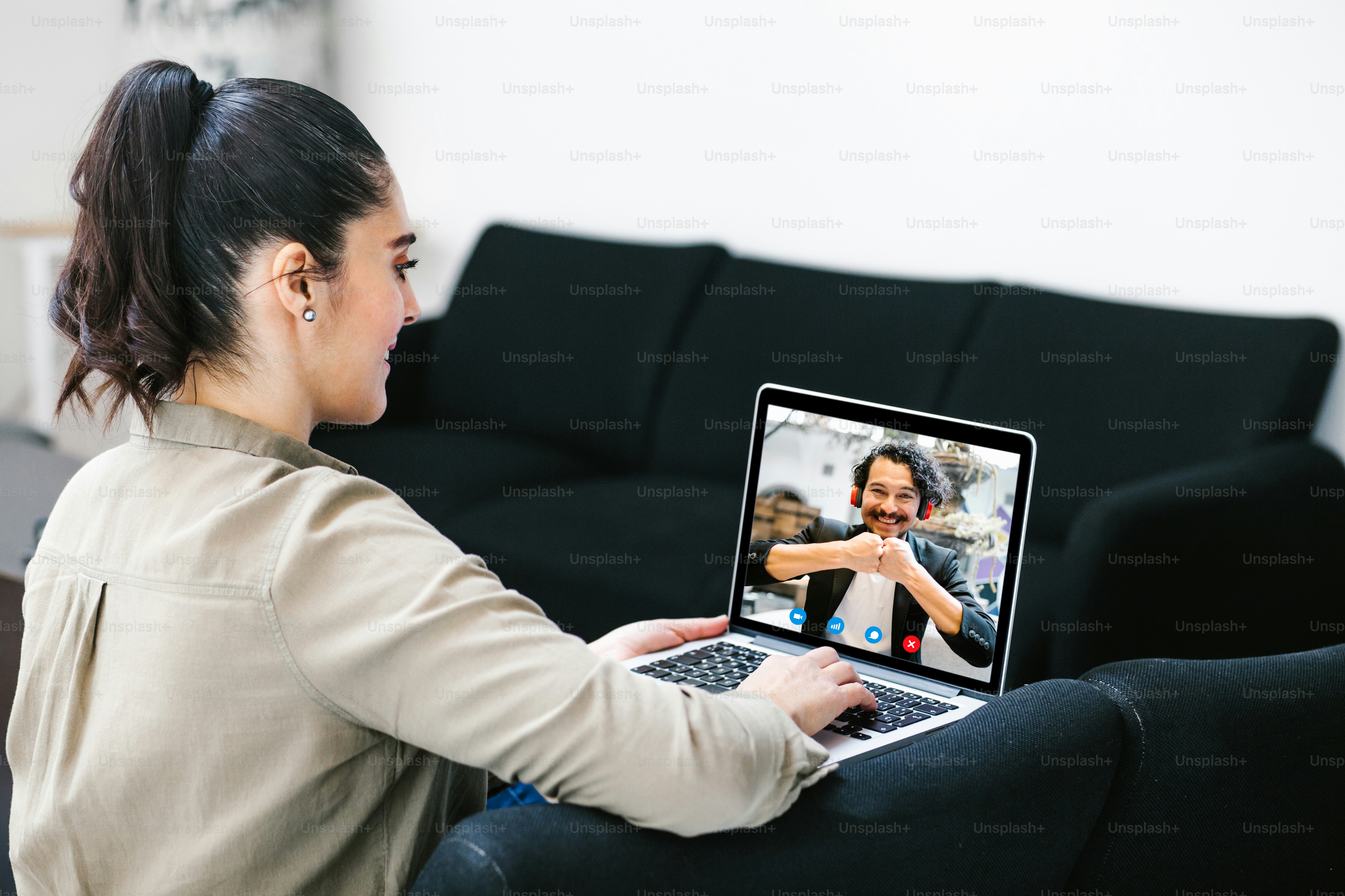 Back view of business latin woman talking to her mexican colleagues in video conference business team using laptop for a online meeting in video call working from home in Latin America
