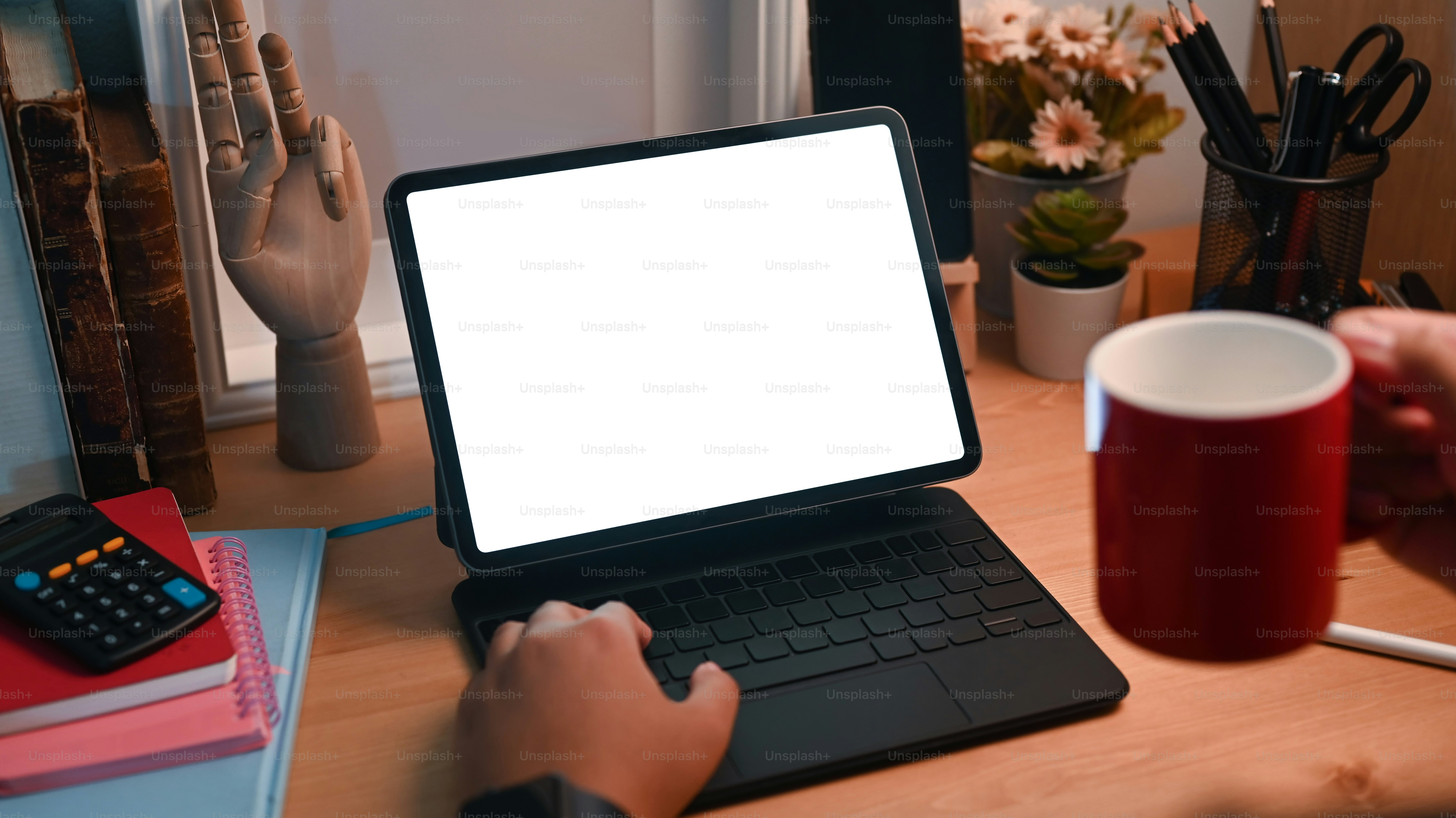 Close up view female drinking coffee and using computer tablet.