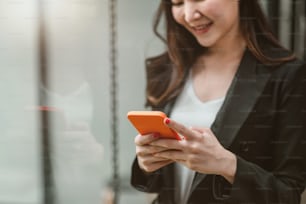 Business woman using smartphone shopping online, call, texting message internet technology lifestyle. Asian woman using cellphone at modern office.