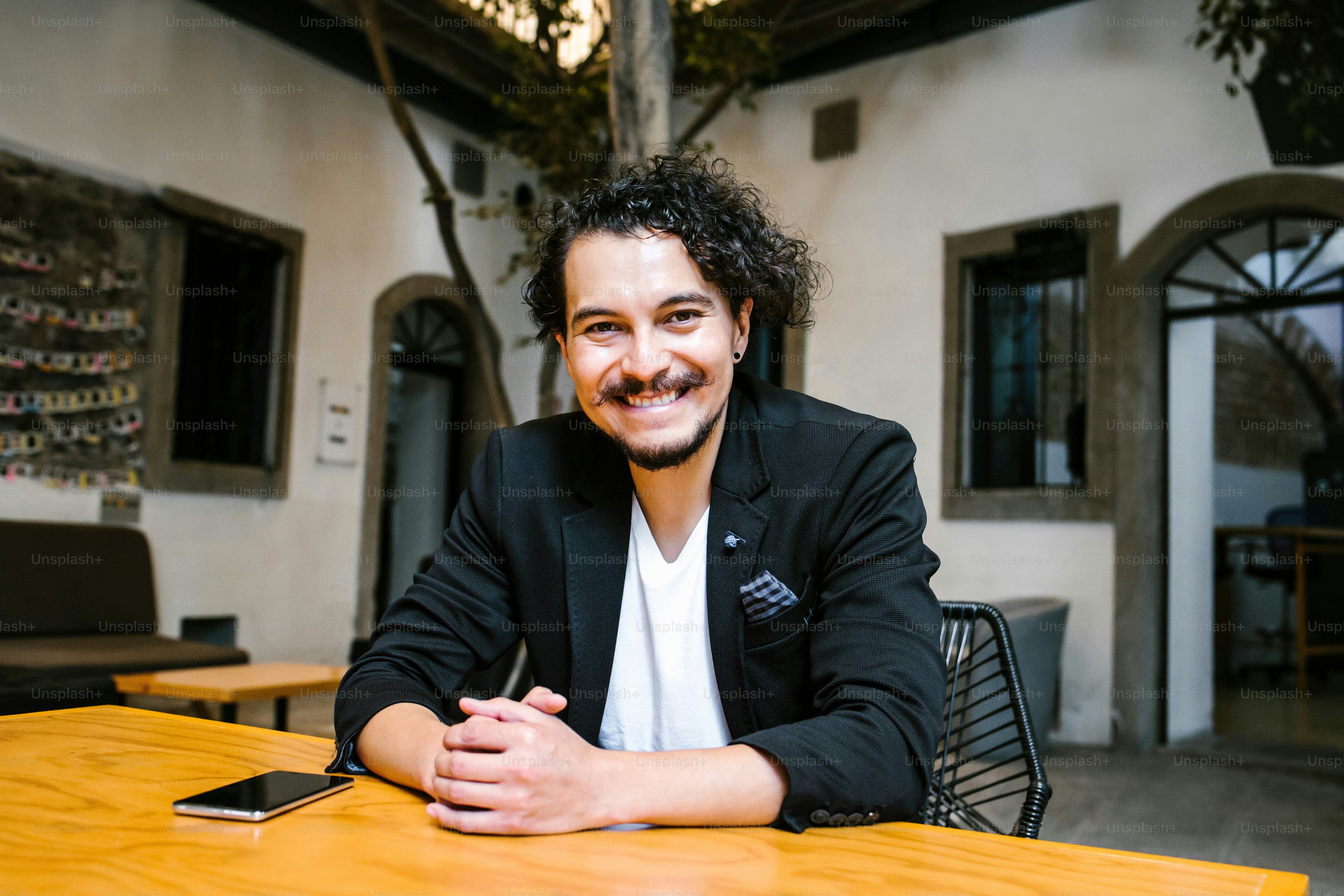 Portrait of latin business man looking at camera in a creative office in Mexico city