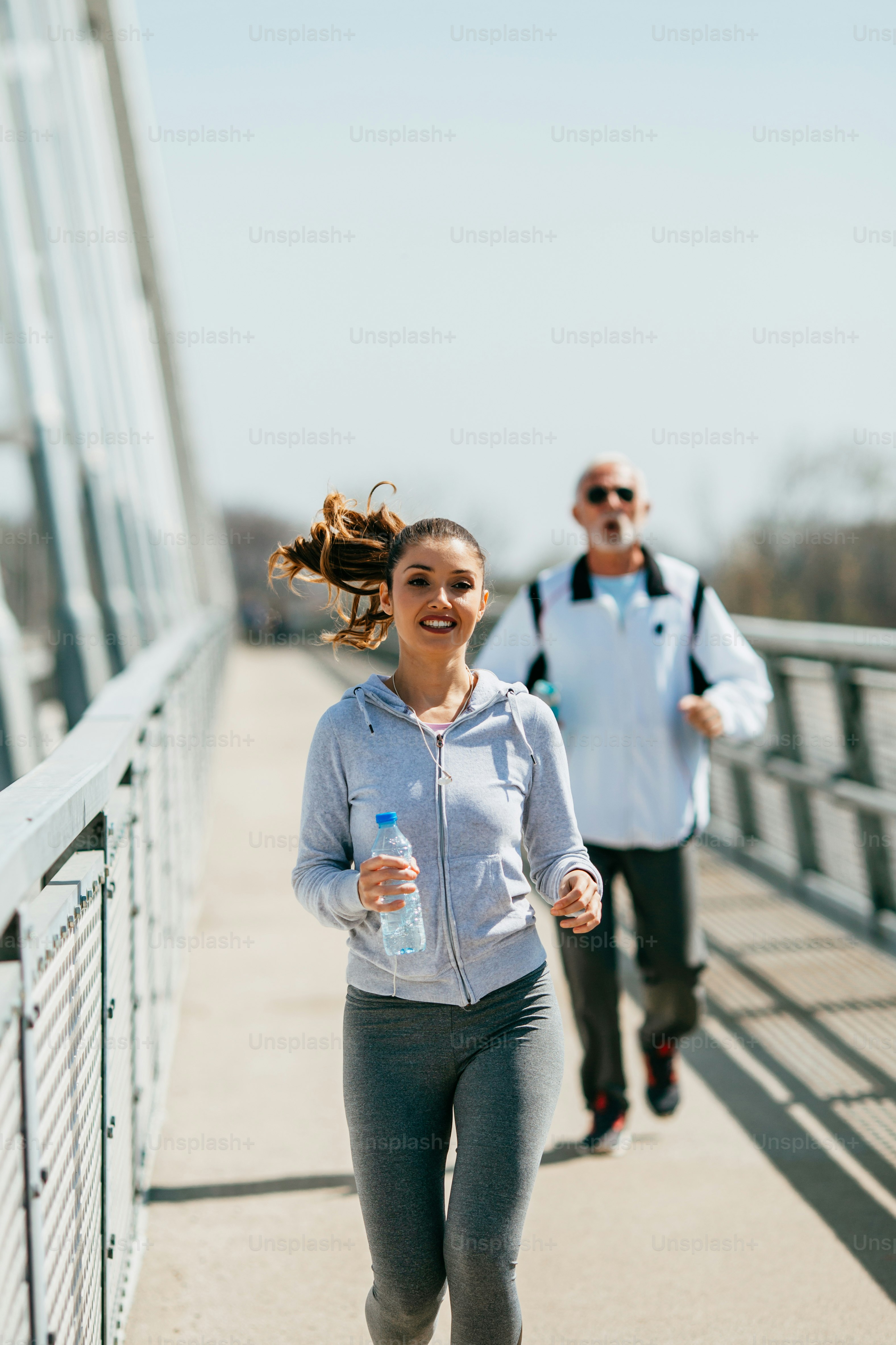 Fit senior man in good shape jogging and exercising together with his ...