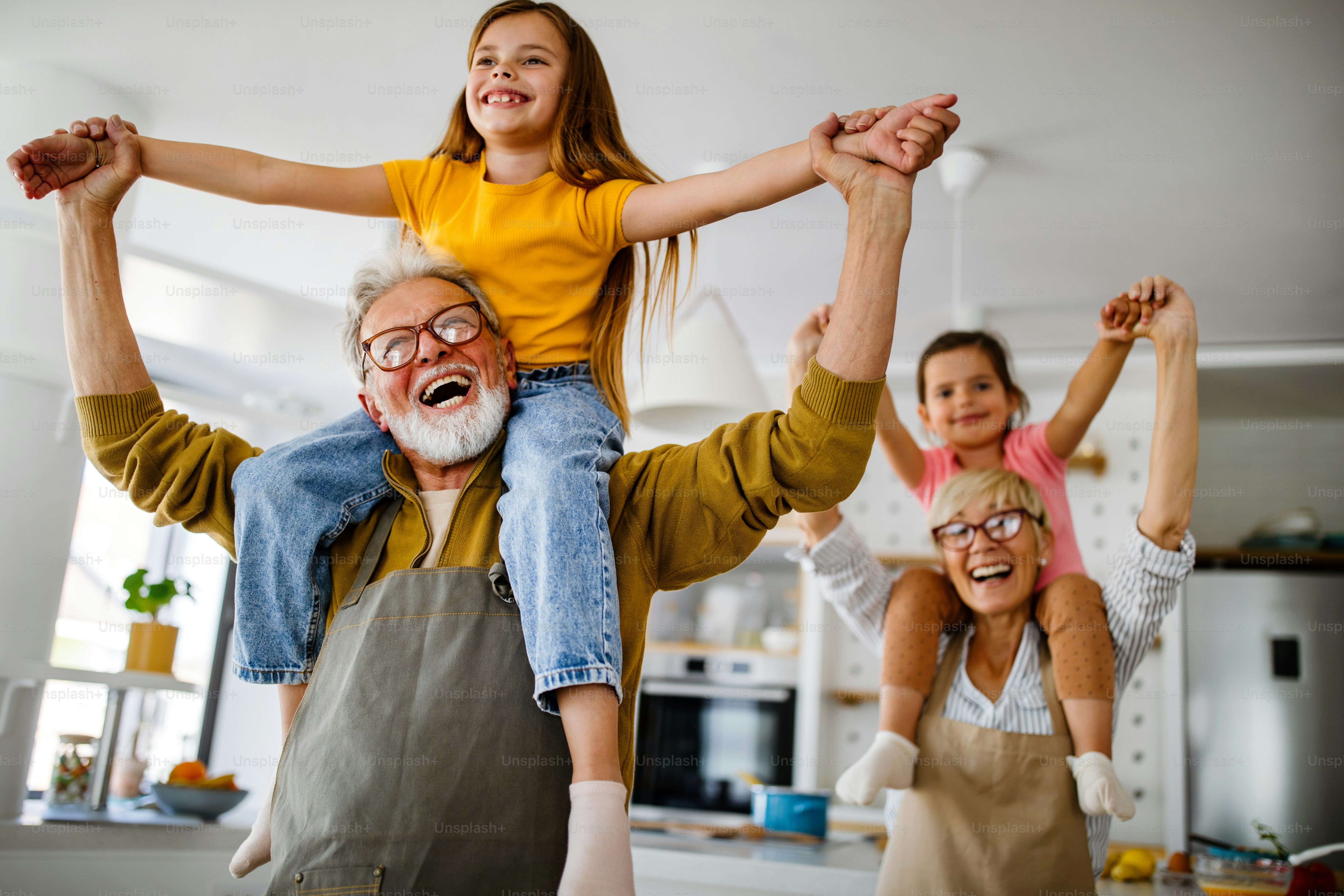 Grandchildren having fun, playing with grandparents at home. Family love generation concept