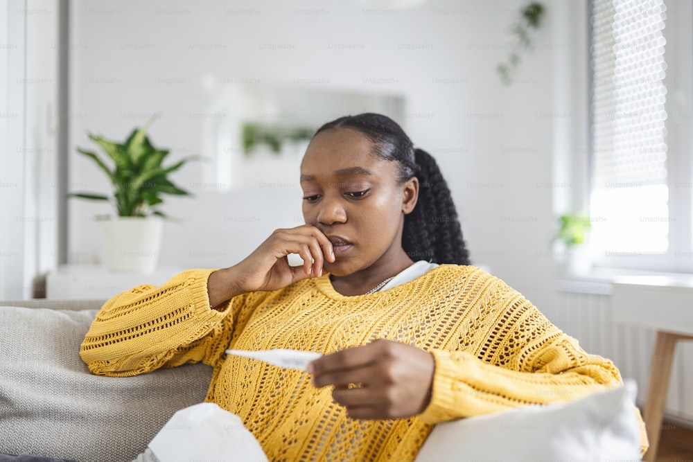 Sick day at home. Young woman has runny and common cold. Cough. Closeup Of Beautiful Young Woman Caught Cold Or Flu Illness. Portrait Of Unhealthy woman with coronavirus, covid19 symptoms