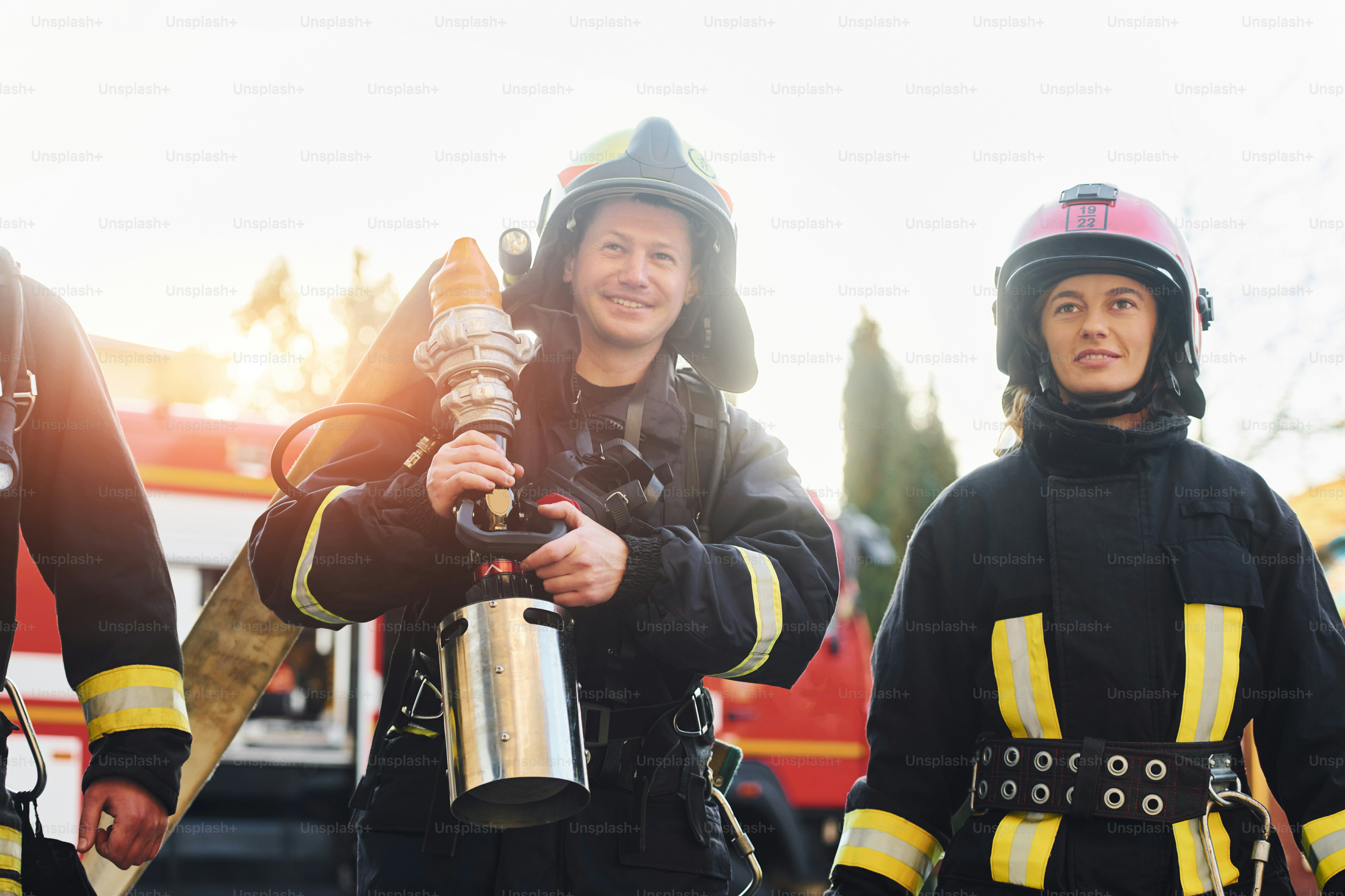 Group of firefighters in protective uniform that outdoors near truck ...