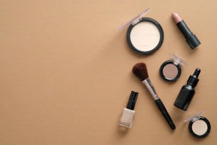 Makeup professional cosmetics on brown background. Flat lay, top view, overhead.