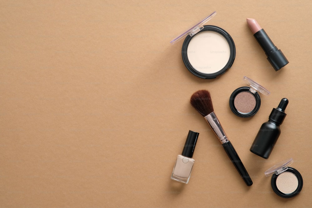 Makeup professional cosmetics on brown background. Flat lay, top view, overhead.