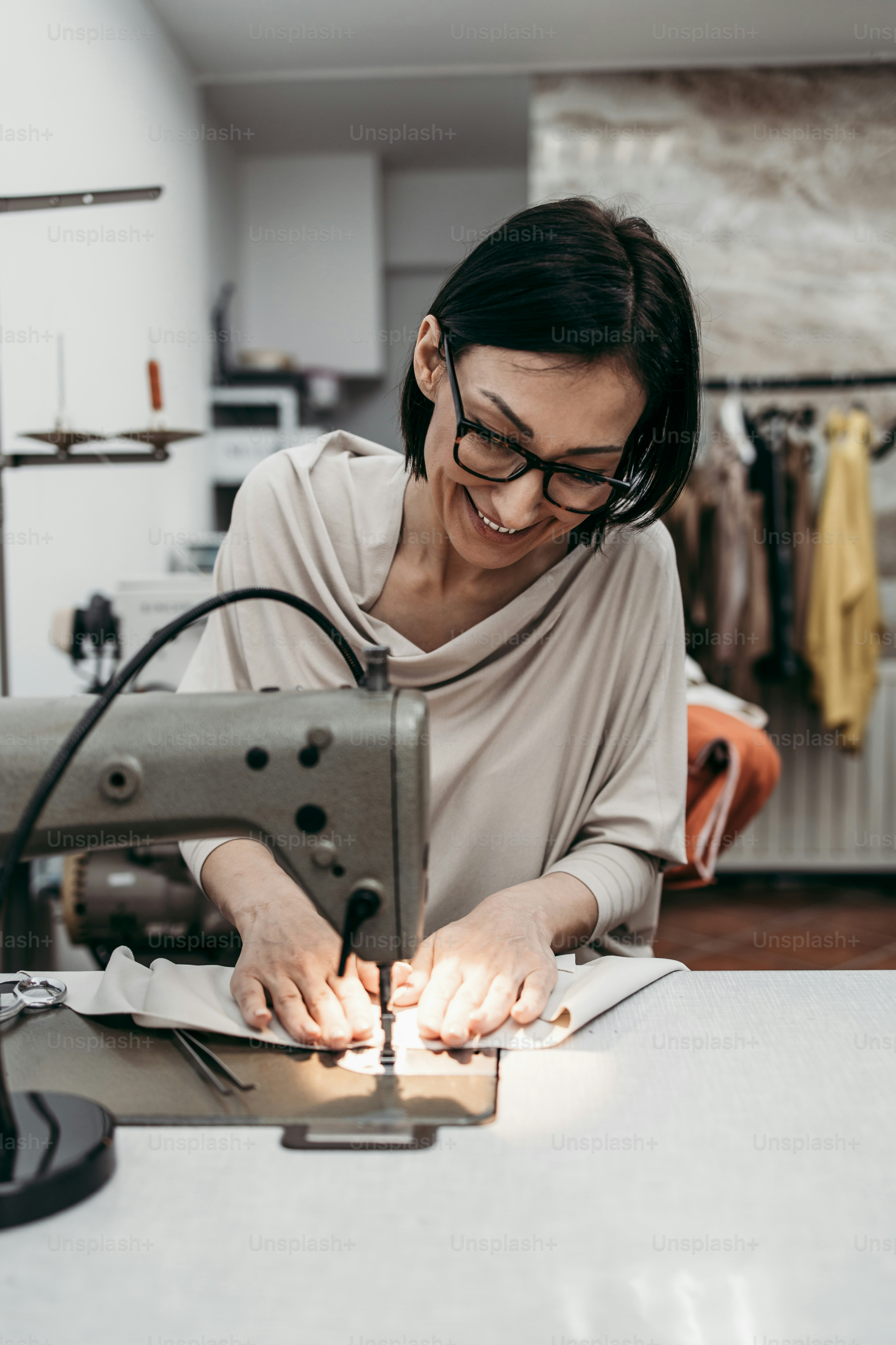 Professional female senior designer working in fashion studio. Creative ...