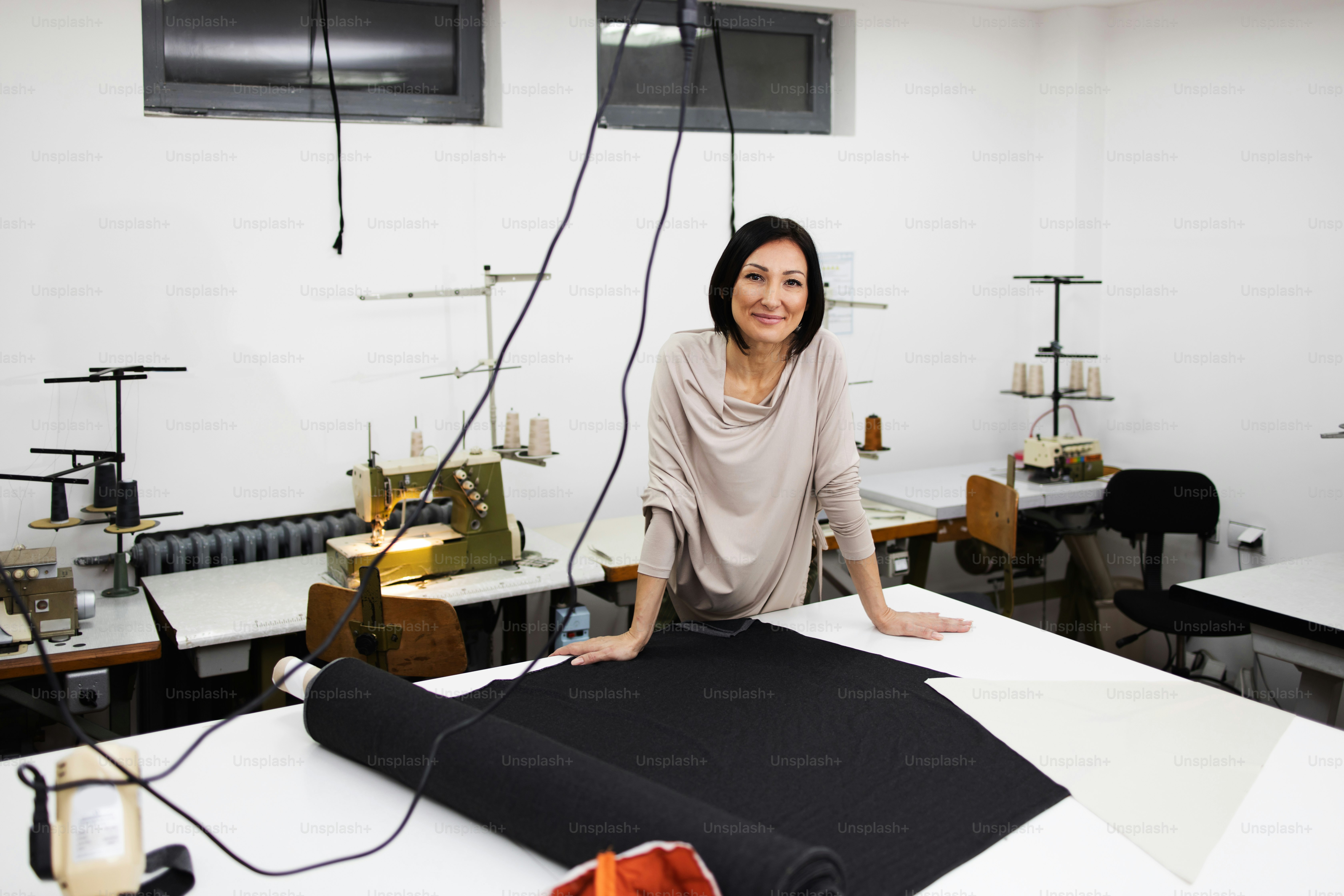 Professional female senior designer working in fashion studio. Creative ...