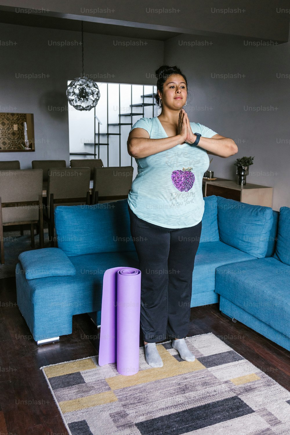 Young curvy mexican woman standing meditating at home in Mexico