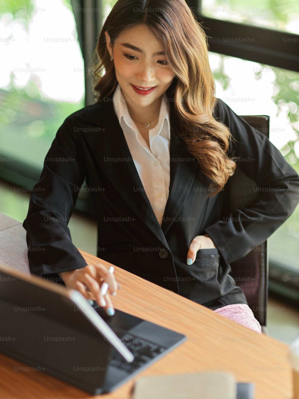 Portrait of young professional  businesswoman using tablet with stylus pen checking financial plan and product development reports