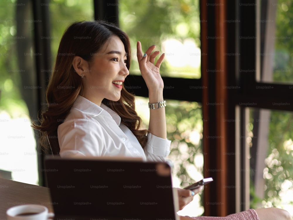 Retrato de bela funcionária asiática, empresária levanta a mão para votar em uma ideia, compartilhando ideia, interativo na reunião