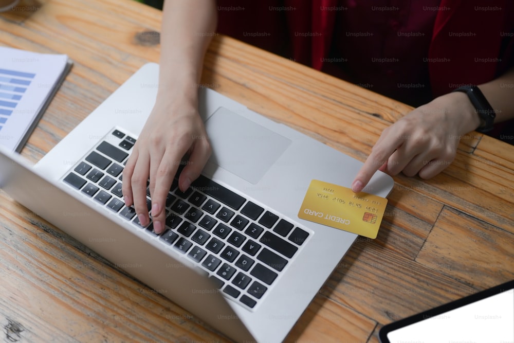 Cropped shot woman payment or banking online with computer laptop.