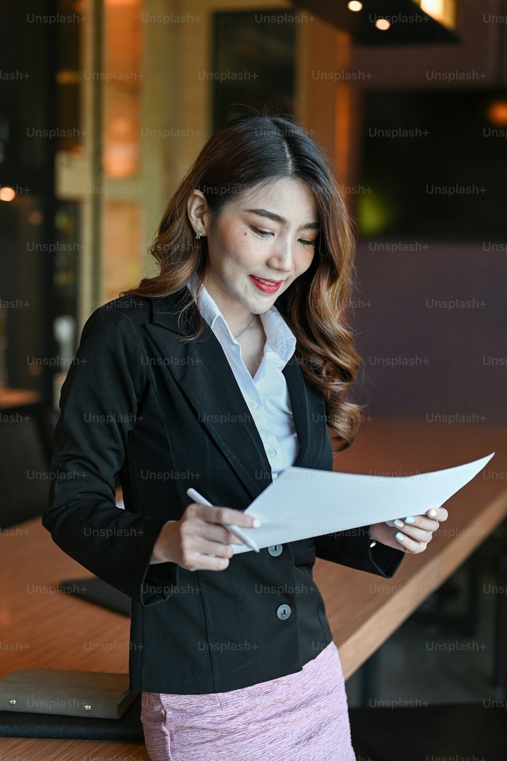 Portrait of attractive businesswoman in standing in modern office.
