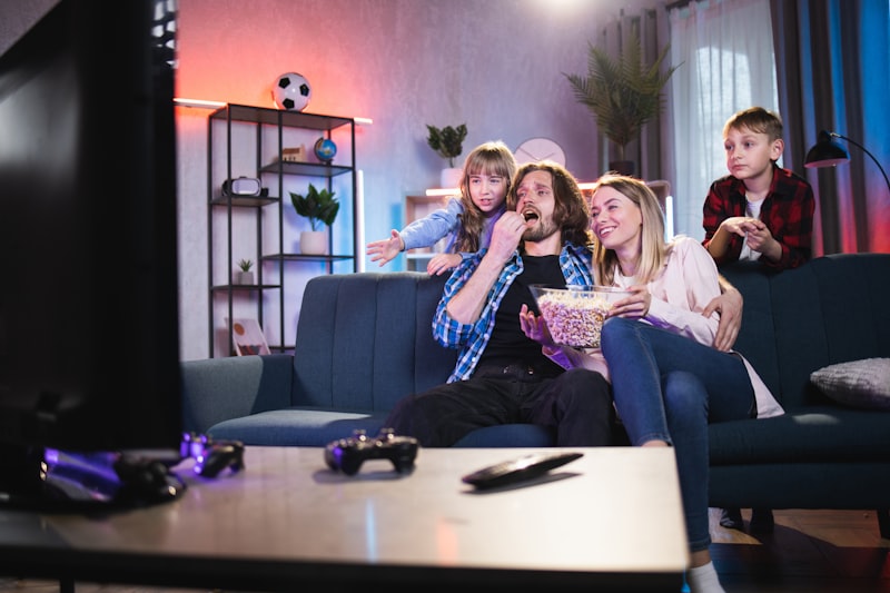 Pais e filhos assistindo filme na TV