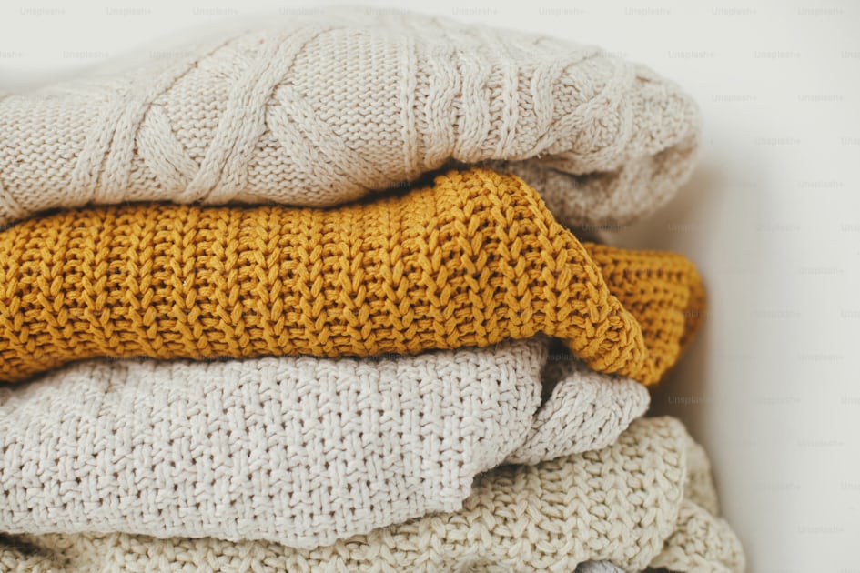 Premium Photo  Pile of woolen clothes as a cozy winter background