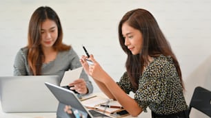 Attraktive Geschäftsfrau mit Kreditkarte am Arbeitsplatz im Büro, Online-Zahlung, Online-Shopping