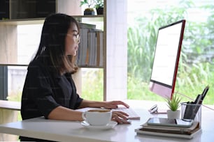 Asian businesswoman working with computer at her office room.
