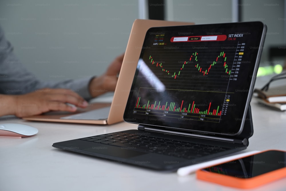 Stock charts on monitor of computer tablet.