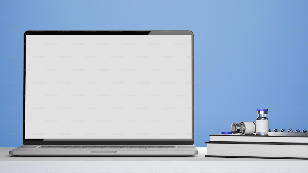 Laptop blank screen mockup, vaccine bottles, medical books on doctor or pharmacist office desk, blue background, 3d rendering, 3d illustration