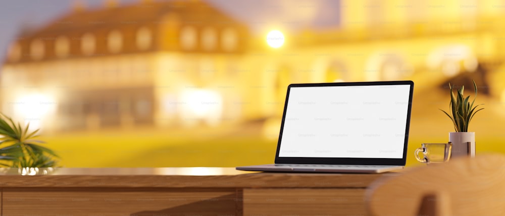 Working desk with laptop mockup and copy space on wooden table top, blurred building light night in the background, 3d rendering, 3d illustration