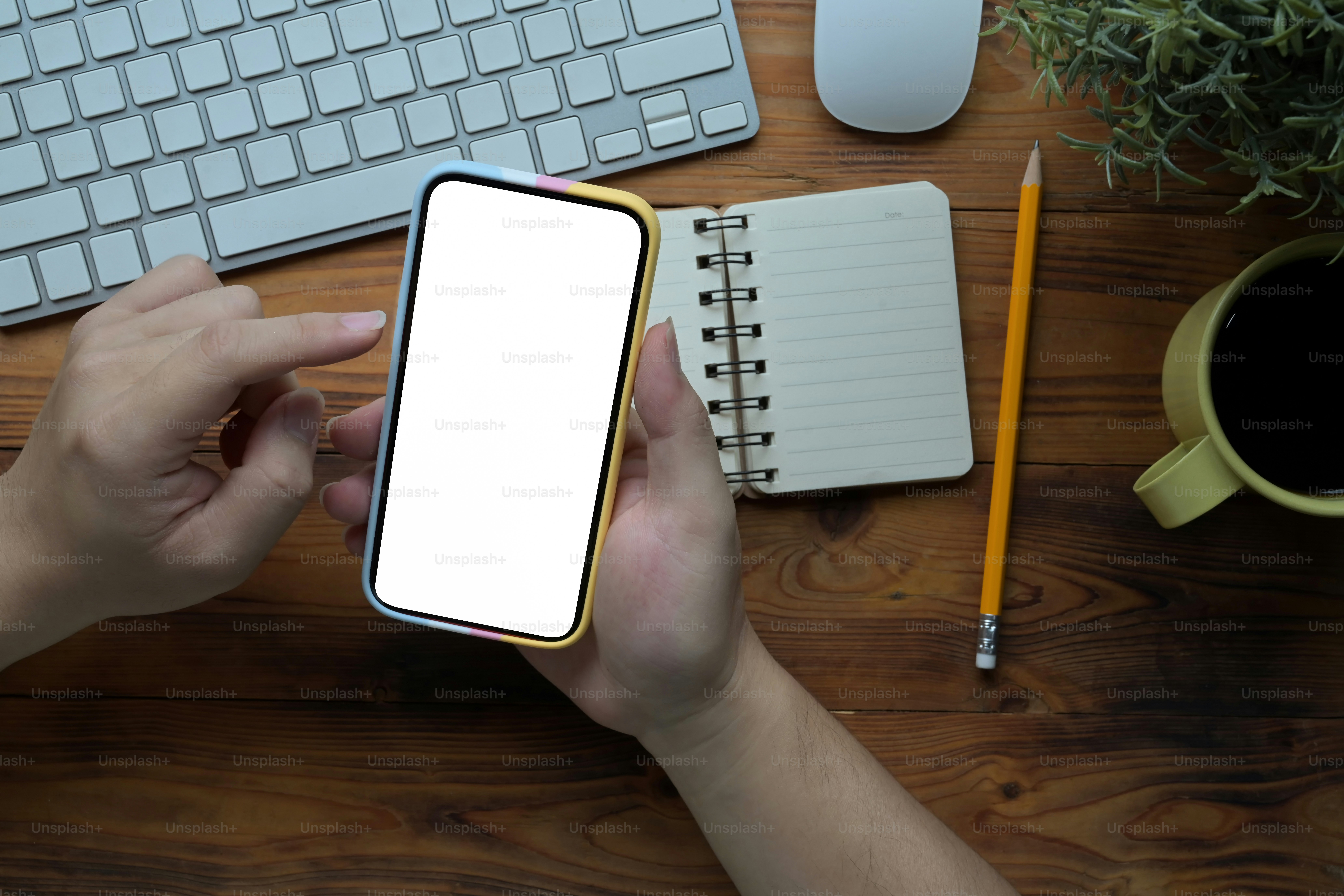 Man using smart phone at his creative workspace.