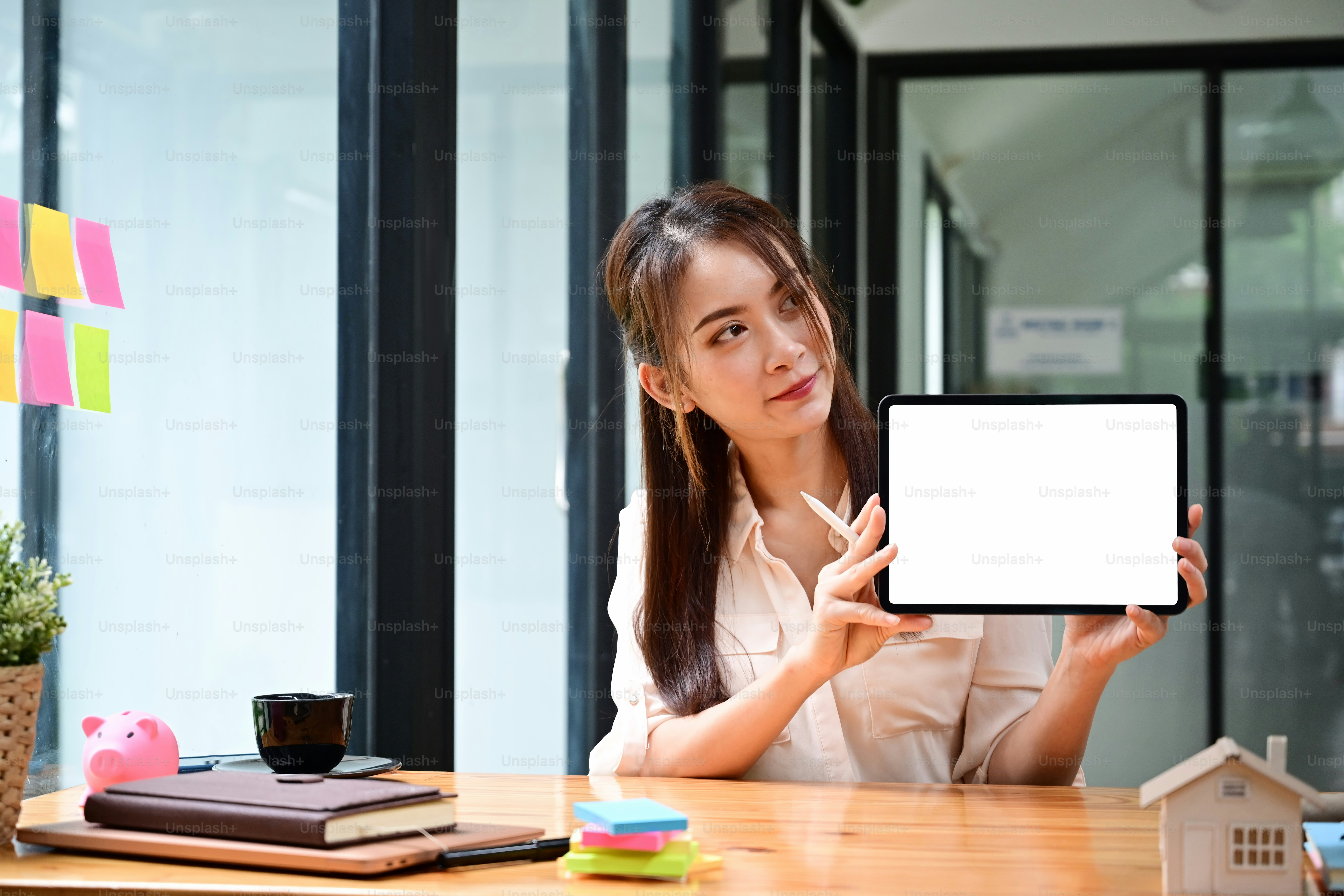 Real estate agent female showing digital tablet with empty display.