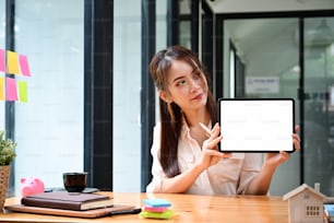 Real estate agent female showing digital tablet with empty display.