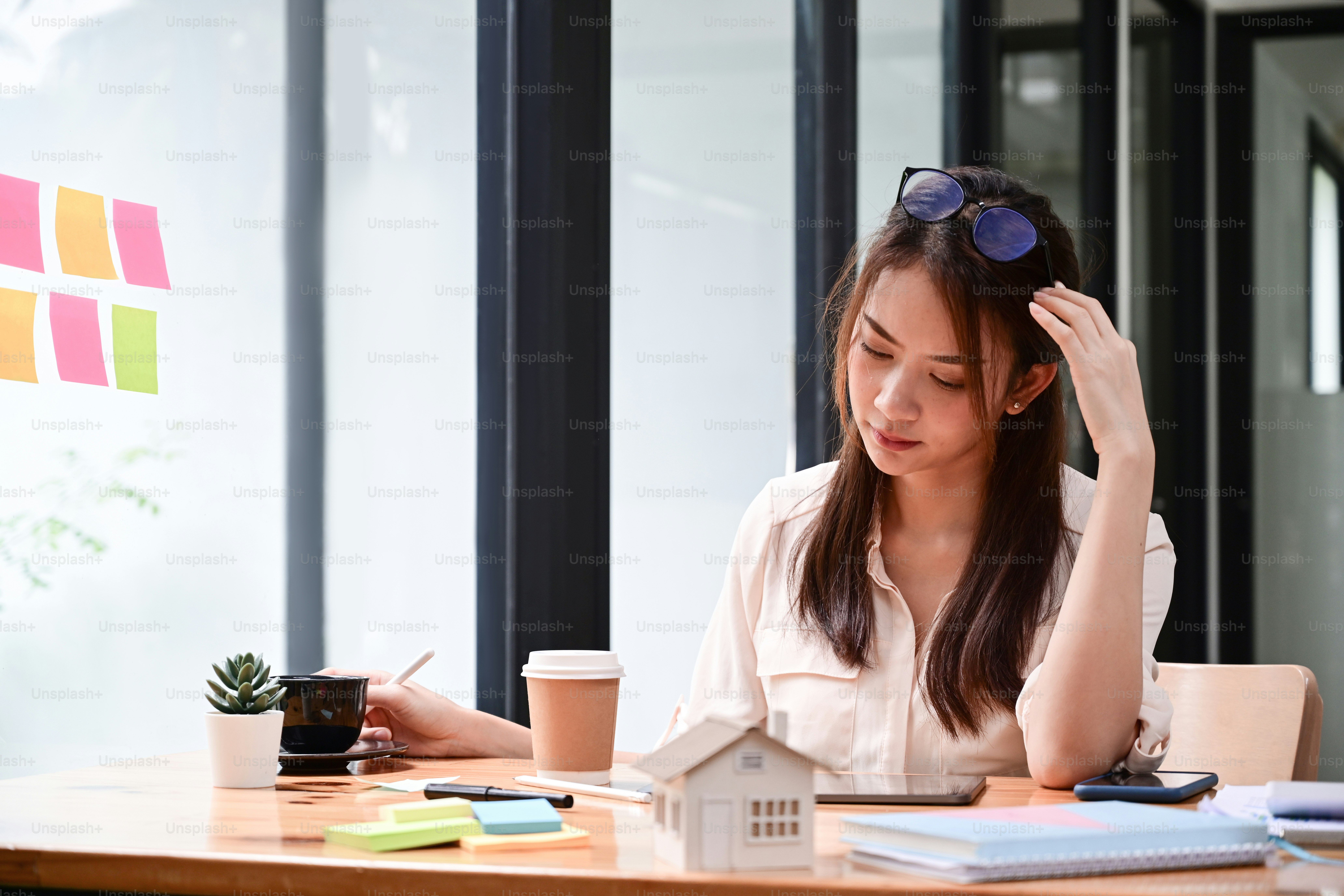 Real estate agent working with digital tablet at her office.